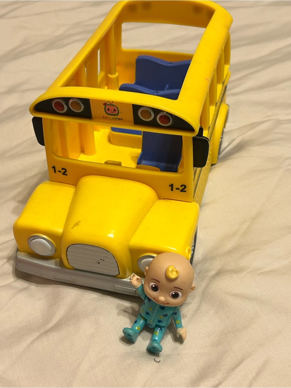 CoComelon Musical School Bus toy featuring a removable JJ figure